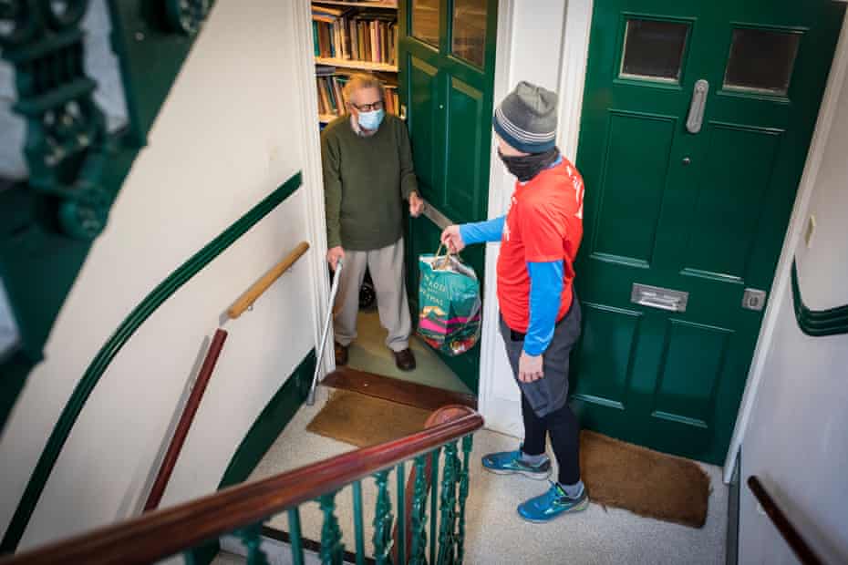 Nick Moore, 49, delivers shopping to Alan Spence, 94. He lives on the second floor in his block and cannot use the stairs