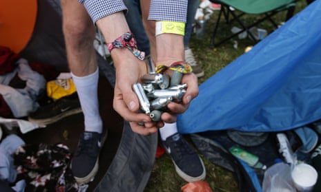 Nitrous oxide canisters in a person's hand