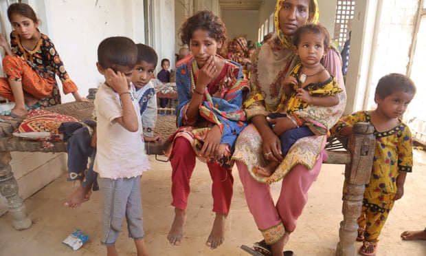Haliman, with her four daughters, who have all fallen ill since the floods.