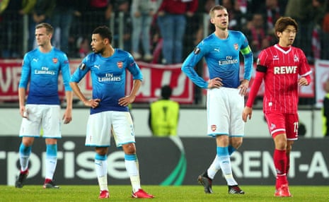 Per Mertesacker of Arsenal and teammates dejected after defeat to Cologne.