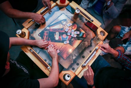 Puerto Ricans play dominoes, a popular game of luck and strategy commonly played in Puerto Rico, at La Placita, a restaurant by chef José Mendín that takes a modern approach to Puerto Rican food, in Miami, Florida.