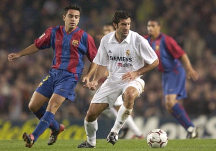 Luis Figo, in Real Madrid white, turns away from a youthful Xavi Hernández in November 2002