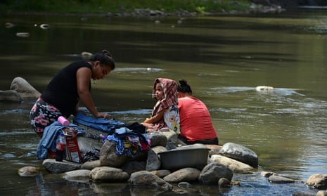 A family washes clothes in the waters of the Guapinol river on the outskirts of Tocoa, Colon department.