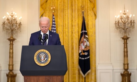 Joe Biden bows his head in a moment of silence as he speaks about the situation in Kabul from the East Room of the White House.