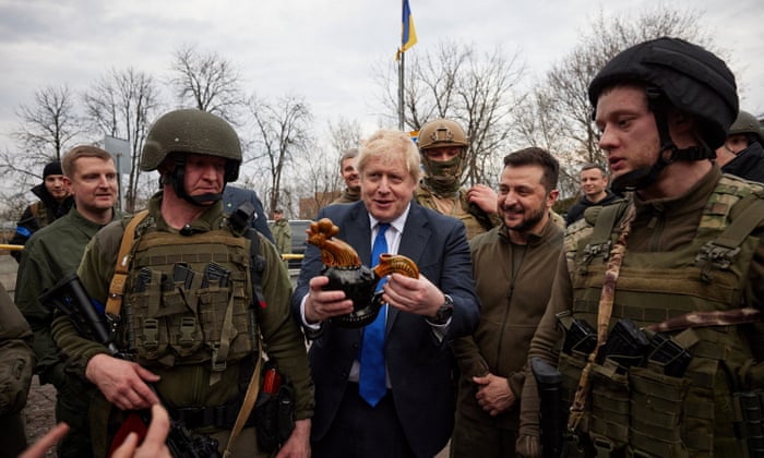 Boris Johnson holds a ceramic rooster presented by local women, the same that were found and survived among debris of a residential building destroyed during Russia’s invasion, in Borodianka town, in central Kyiv, Ukraine April 9, 2022.