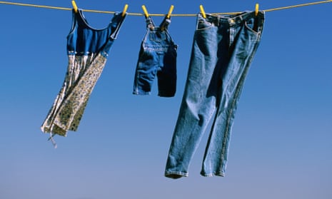 Denim hanging on a yellow clothesline.