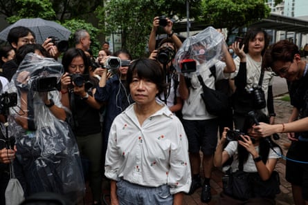 A woman surrounded by media and people A woman surrounded by media and people