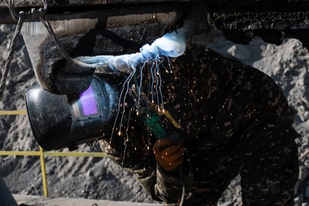 Ali Umarov fixes an excavator in the coalmine near Sary-Mogol.
