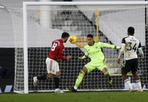 Fulham’s goalkeeper Alphonse Areola makes a save in front from Manchester United’s Bruno Fernandes.