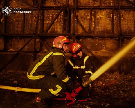 Rescuers extinguishing a fire at the site following an air attack in Poltava region, amid the Russian invasion of Ukraine.