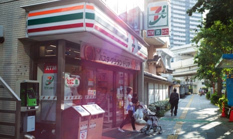 A customer leaves a 7-Eleven convenience store, in Tokyo japan