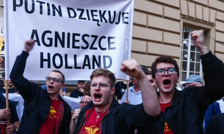 Far-right activists demonstrate against in front of a banner reading ‘Putin thanks Agnieszka Holland’