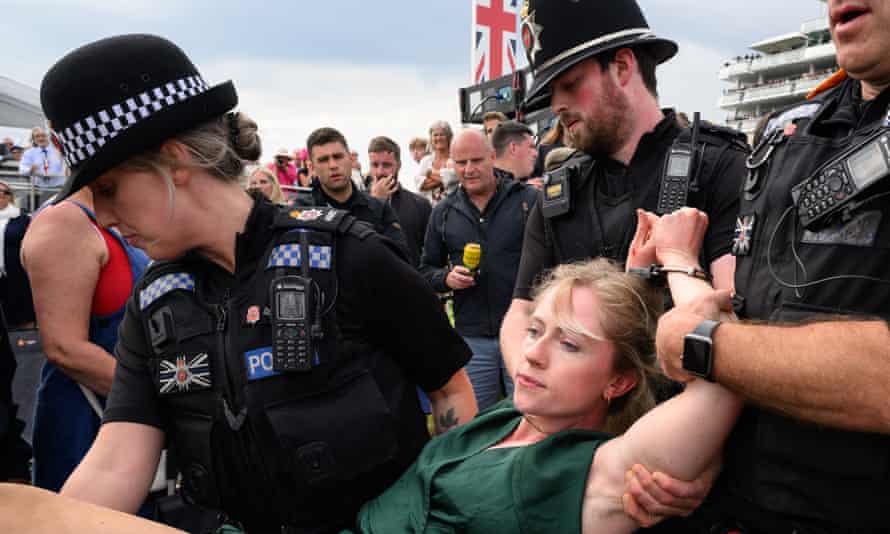 Animal Rebellion protesters run on to track before Epsom Derby | Animal welfare 1 An animal rebellion activist is arrested after running on to the racecourse on day two of the Epsom Derby.