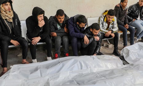 People mourn as they collect the bodies of friends and relatives killed in an Israeli airstrike on Friday in Rafah, southern Gaza.