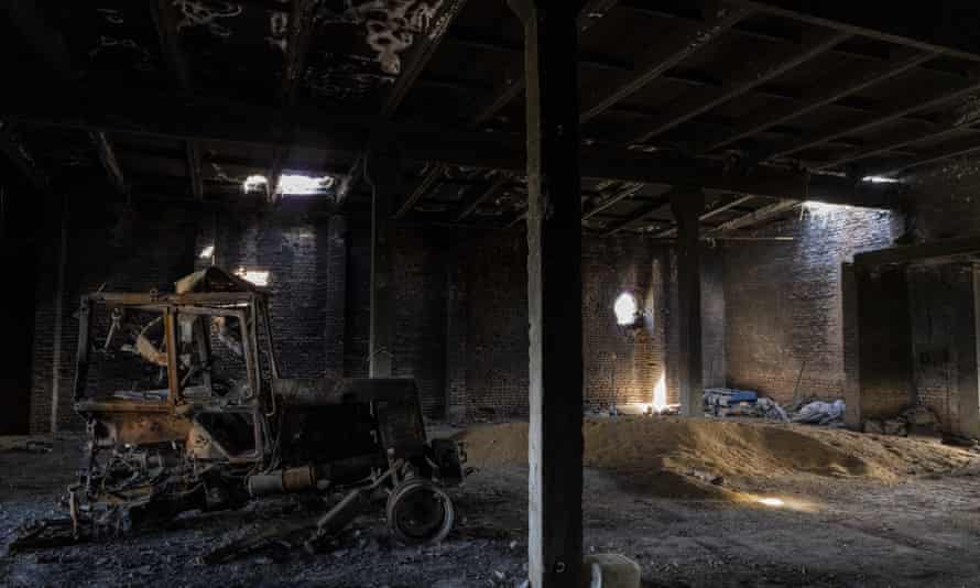 A tractor charred by a Russian attack lies inside a warehouse at a grain farm in Cherkaska Lozova, outskirts of Kharkiv, eastern Ukraine. Ukraine is one of the world’s largest exporters of wheat, corn and sunflower oil, but the war and a Russian blockade of its ports have halted much of that flow. Many of those ports are now also heavily mined.