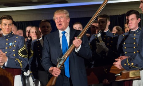 Donald Trump holds up a replica flintlock rifle awarded him by cadets during the Republican Society Patriot Dinner at the Citadel Military College.