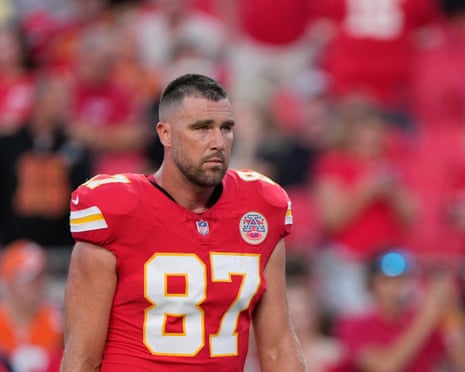 Travis Kelce walks without a helmet before a Kansas City Chiefs game.