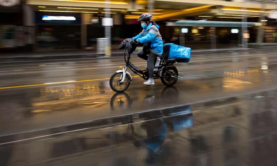 A food delivery rider in the rain in Melbourne