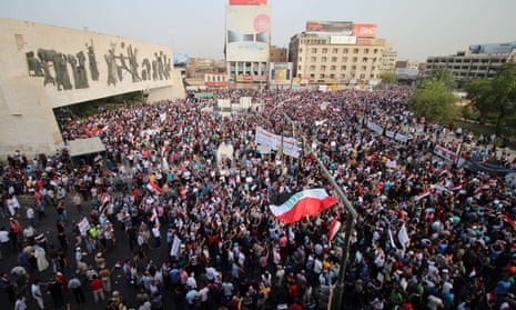 Iraqis wave their national flag during a demonstration against corruption and poor services in Baghdad.