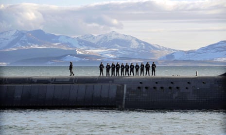 British Navy personnel stand atop the nuclear submarine HMS Victorious off the west coast of Scotland.