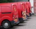 Four red Royal Mail vans in a car park