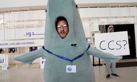 A person in a dugong costume stands near a sign that says CCS, carbon capture and storage, at the COP28 U.N. Climate Summit, Monday, Dec. 11, 2023, in Dubai, United Arab Emirates. (AP Photo/Kamran Jebreili)