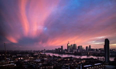 Dramatic and colourful morning sunrise over Canary Wharf in London<br>23 Nov 2015, London, England, UK --- London, United Kingdom. 23rd November 2015 -- Cold wintery air brings dramatic light and pinky/orange colours to a morning sunrise over Canary Wharf business park buildings and River Thames in central London, UK. -- The cold wintery air brings dramatic light and pinky/orange colours to a morning sunrise over Canary Wharf business park buildings in central London, UK. --- Image by © Guy Corbishley/Demotix/Corbis
