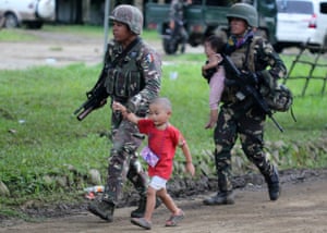 Filipino soldiers escort children in Marawi