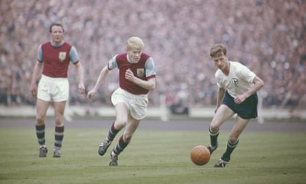 Burnley's Ray Pointer races away from John White of Tottenham during the 1962 FA Cup final.