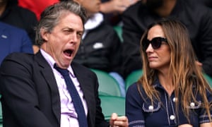Hugh Grant and Anna Elisabet Eberstein watch Federer on centre court.