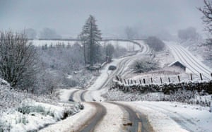 A car is stuck on a snowy road near Garsdale in Cumbria
