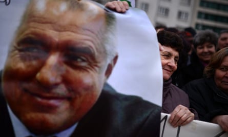 A woman holds a poster of Borisov