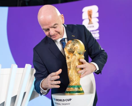 Fifa president Gianni Infantino holds the World Cup trophy
