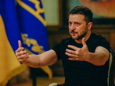 Volodymyr Zelenskiy gestures with his arms out in front of him during the interview