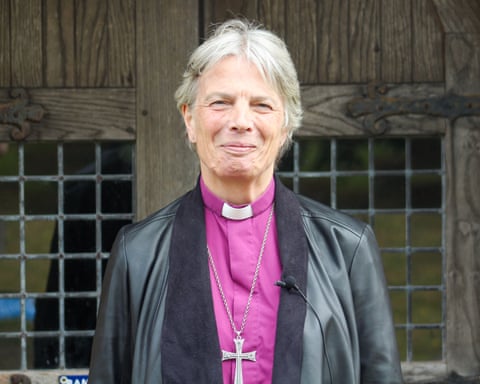Archbishop Cherry Vann wearing a purple shirt and dog collar with silver cross chain.
