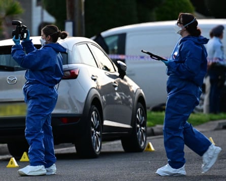 Police detectives and forensics officers at the scene after the shooting in Merrylands West