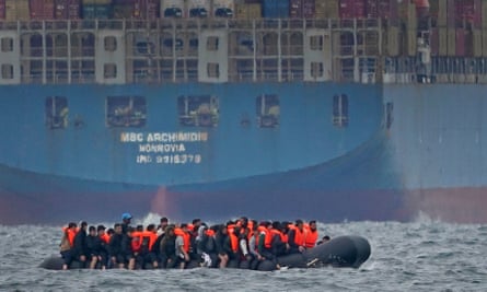A group of people attempting to cross the Channel in a small boat