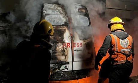 a destroyed vehicle near Al Awda hospital following an Israeli airstrike in Al Nuseirat refugee camp, central Gaza Strip