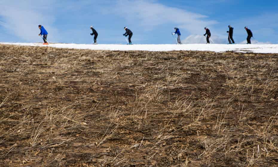 Skiers thread their way through patches of dry ground at California’s Squaw Valley ski resort. Several Lake Tahoe-area ski resorts have closed due to low snowfall as California’s historic drought continues. 