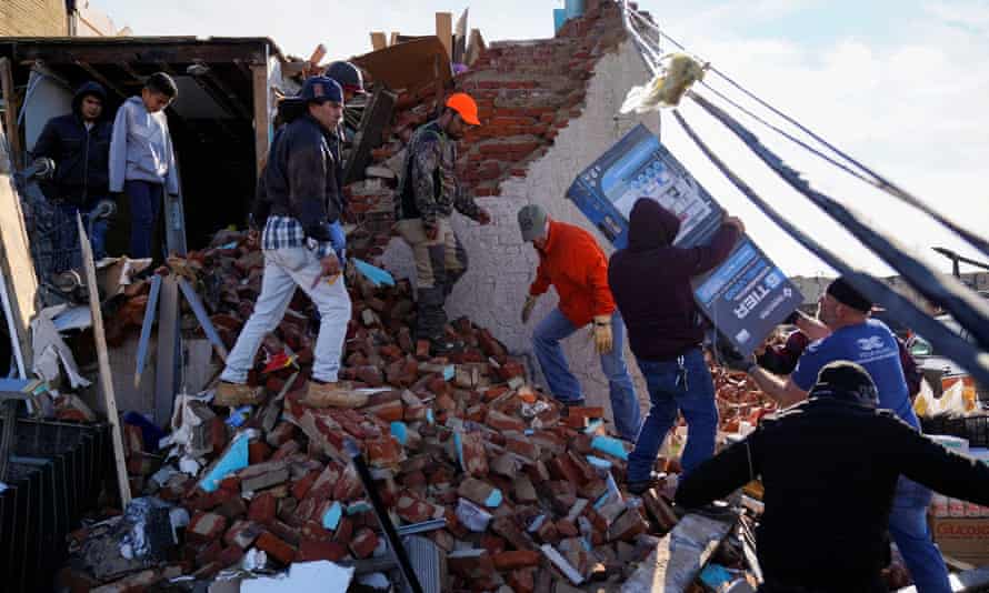 Helpers sift through the wreckage in Mayfield, Kentucky.