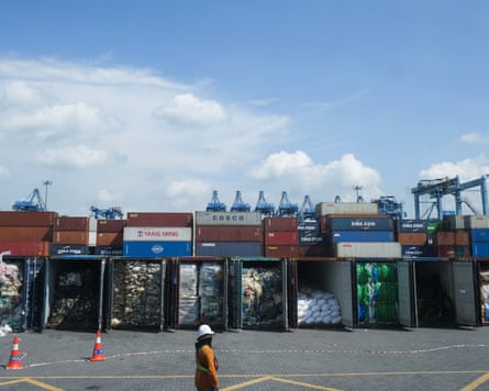 A row of shipping containers filled with plastic waste