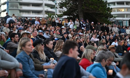 People are seen during a candlelight vigil to honour the victims of the Bondi Junction attack