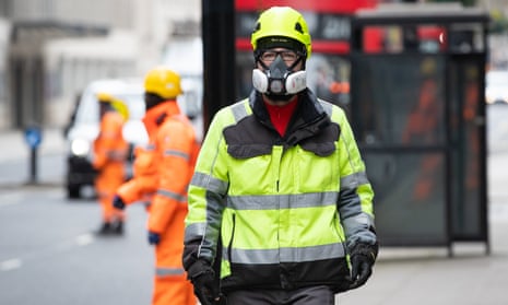 A construction worker wears a protective face mask in London before the lockdown.