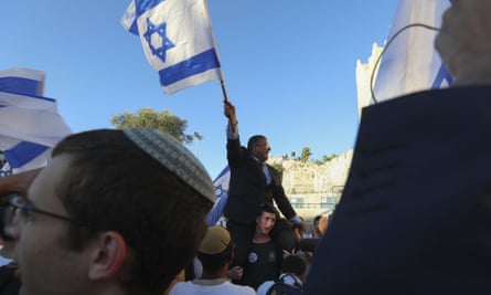 Knesset member Itamar Ben-Gvir waves an Israeli flag together with other ultranationalists during the “Flags March” in Jerusalem on Tuesday.