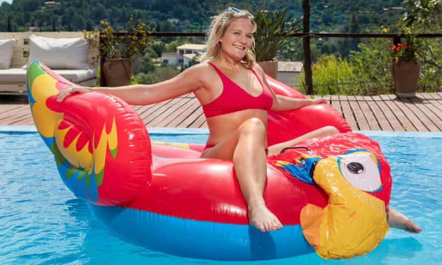 Bella Younger on an inflatable parrot, in a swimming pool