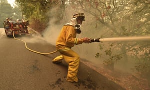 Eagle Field Fire Department firefighter Mark Jones extinguishes hot spots during the Glass Fire in St. Helena, California.