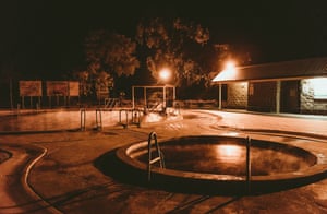 People enjoying a soak in the Artesian Bore Baths in Lightning Ridge, open 24 hours a day.