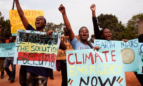 Young people holds up banners as they take part in a climate march in Wakiso, Uganda. The Jubilee Debt Campaign said poorer countries will be raising the impact of debt at the meeting.