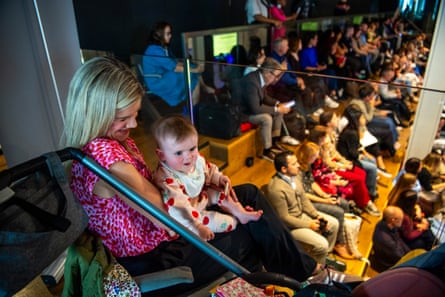 A mother and baby with audience below