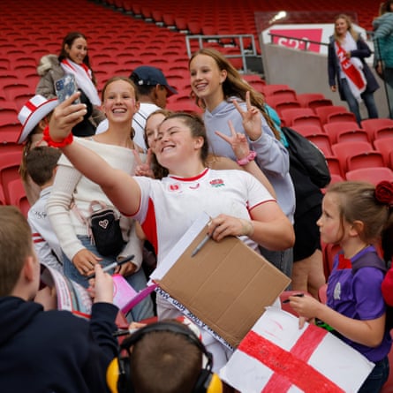 Maud Muir, the England prop forward, signing autographs and taking selfies in the stands well after the finish of the semi-final against France.